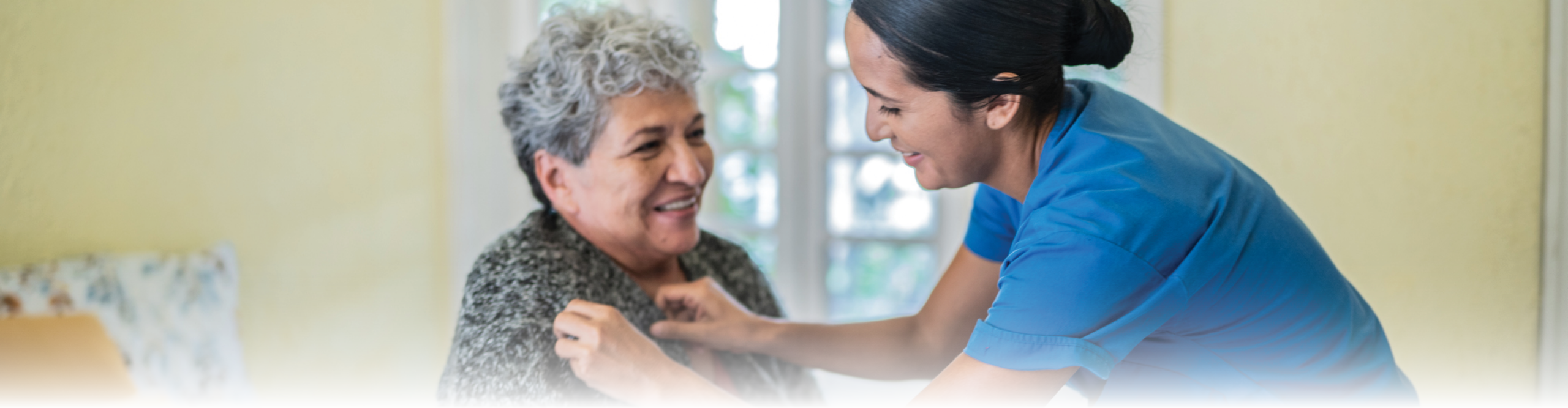 Nurse helping resident dress